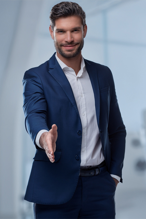 Business man, in a suit, offering a handshake